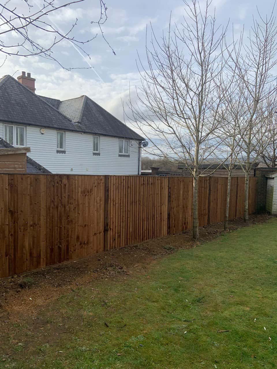 This is a photo of feather edge fencing installed in a residential properties garden by Fast Fix Fencing Upwell